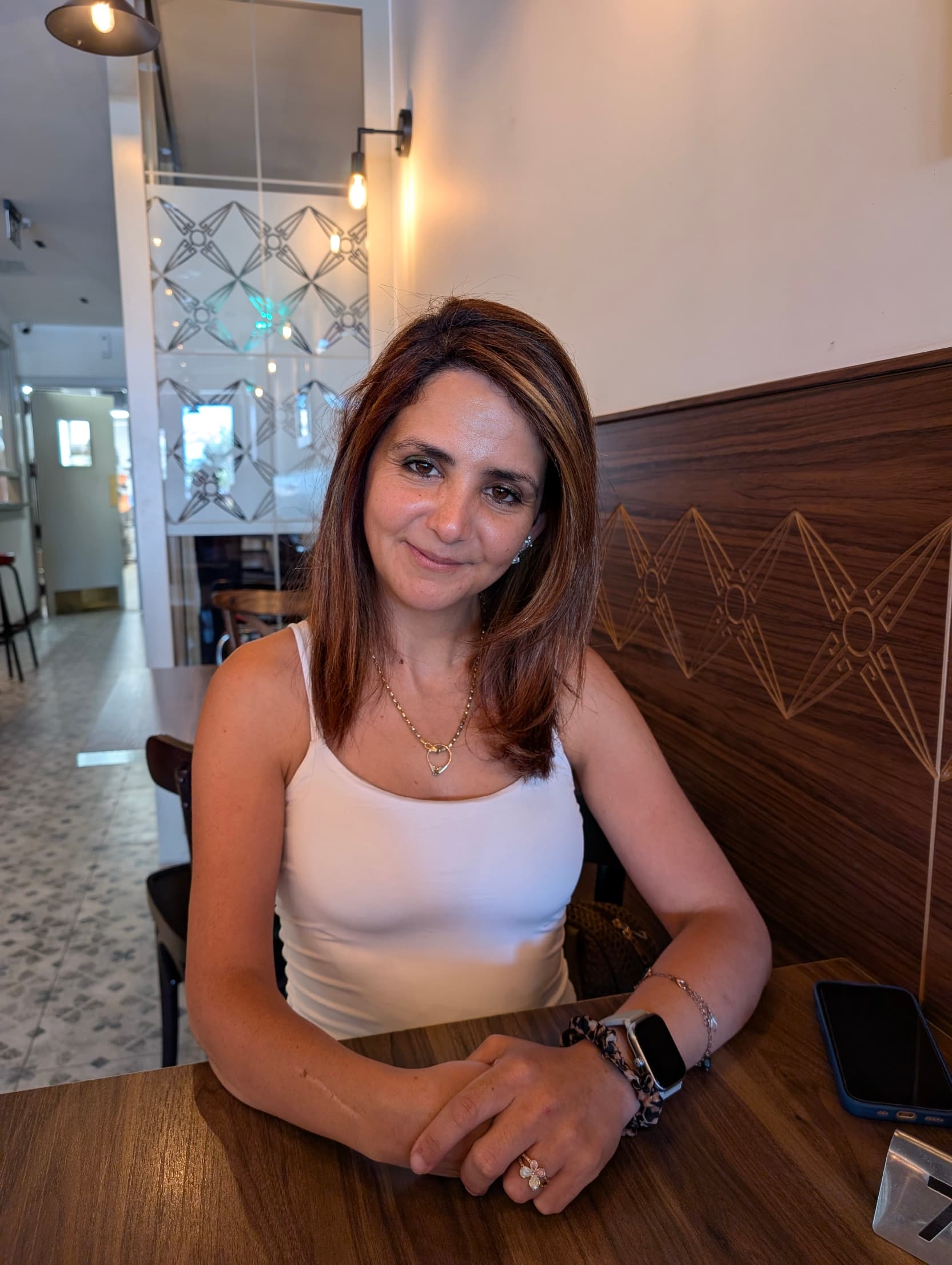 Portrait of Nicole Vella, Founder of Somavera Wellness Lab, wearing a neutral-toned blazer with healthy, radiant skin.